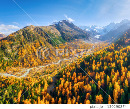 Drone view of a mountain valley. River in the middle of the forest. Autumn landscape from the air. 130290274