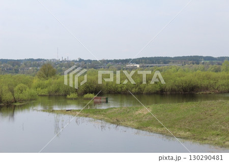 spilling the river in spring on the plain. The river came out of the banks. Natural phenomenon spilling the river in spring on the plain. The river came out of the banks. Natural phenomenon 130290481