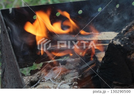 bonfire fire with smoke close-up in the dark on a black background. Burning wood, wood 130290500