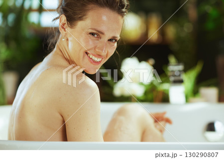 Joyful Woman Relaxing in a Luxurious Bath 130290807