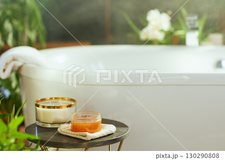 Inviting Body Scrub and Candle for a Relaxing Bath 130290808