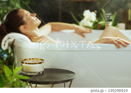 Woman Enjoying a Relaxing Candlelit Bath 130290810