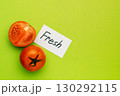 Red tomato with note Fresh on green background, organic food concept 130292115