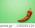 Red chili pepper on green background, minimal food concept 130292116