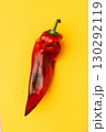 Red chili pepper on yellow background, fresh vegetable 130292119