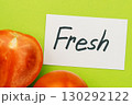 Closeup of Fresh note with tomato on green background, minimal concept 130292122