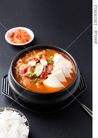 Korean food (Kimchi Jjigae), Kimchi soup with tofu and pork in bowl eating with rice and kimchi 130293612