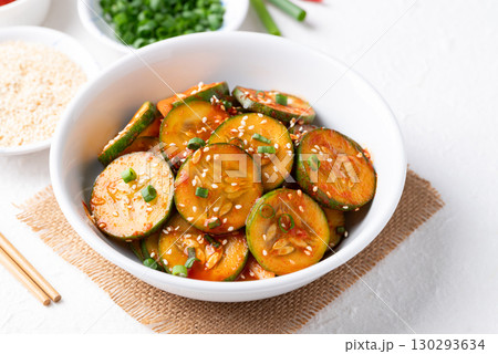 Korean cucumber salad (Oi muchim) in bowl on white background, Korean side dish Korean cucumber salad (Oi muchim) in bowl on white background, Korean side dish 130293634
