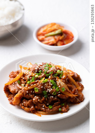 Korean stir fried spicy pork (Bulgogi) with cooked rice and kimchi on white background 130293663