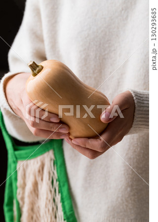 Butternut squash pumpkin holding by woman hand 130293685