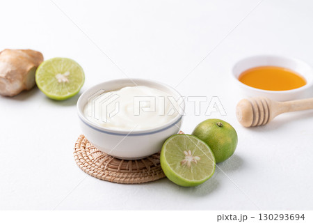 Yogurt, lime, honey and ginger on white background 130293694