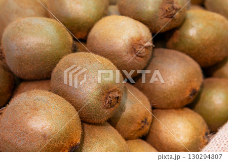 Lots of kiwi fruits on the counter in the store. Close-up. selective focus 130294807