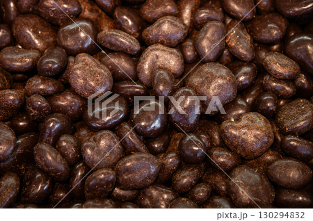 Nut balls covered with brown chocolate. Walnuts in chocolate glaze. Many top view 130294832