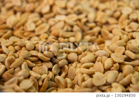 Dry peanuts with salt roasted without skin. Side view background. Healthy spices, nuts, seeds and plant products. 130294850
