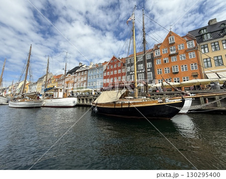 Scenic summer view of color buildings and boats of Nyhavn in Copenhagen, Denmark Scenic summer view of color buildings and boats of Nyhavn in Copenhagen, Denmark 130295400