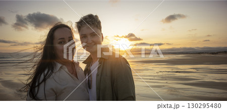 Lesbian couple enjoying romantic sunset on beach Lesbian couple enjoying romantic sunset on beach 130295480