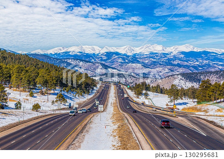 Interstate 70 in Rocky Mountains with snow covered peaks 130295681