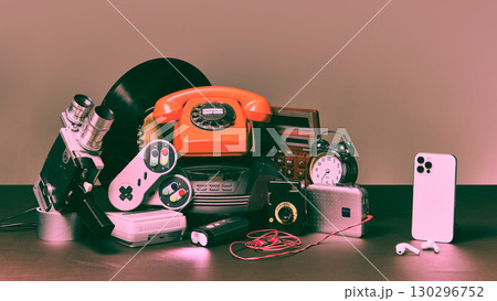 Retro technology objects with modern smartphone on dark surface Retro technology objects with modern smartphone on dark surface 130296752