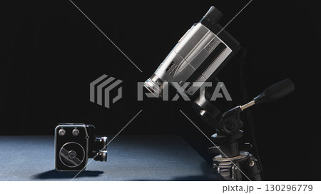 Vintage and modern video cameras facing each other in symbolic contrast 130296779