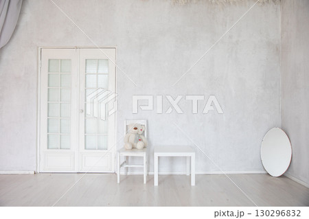 Chair, table and mirror in the interior of an white room with a door Chair, table and mirror in the interior of an white room with a door 130296832
