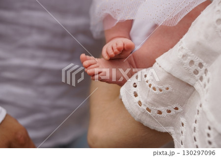 Tender Moment: Mother Holding Newborn Baby's Feet in White Lace, Soft Focus, Cream and Pale Skin Tones, Family Love, New Life Concept. 130297096