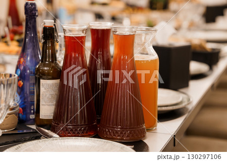 Rustic Table Setting with Assorted Beverage Carafes and Bottles. Dark Tones, Food Service, Event Hospitality, Drink Variety, Modern Interior Design 130297106