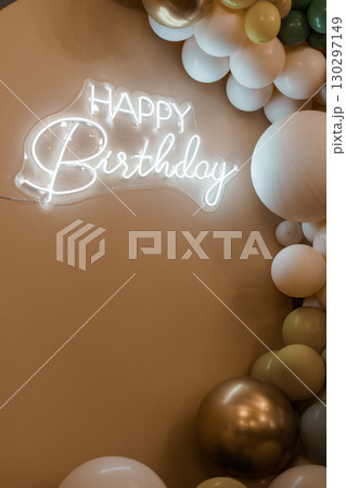 Elegant Birthday Backdrop with Neon Sign and Balloon Garland in Cream, White, and Gold Tones for Party Decorations. 130297149