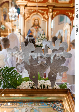 Holy Wedding Ceremony with Silver Heart Decorations at Church Altar. White Flowers and Religious Art 130297181