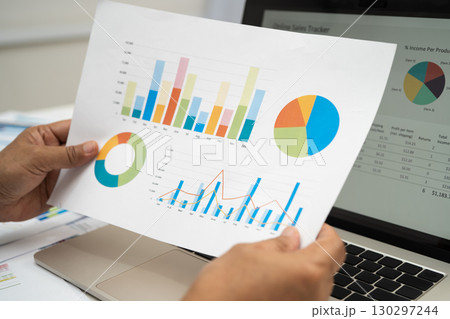 Asian business woman working with financial graph. 130297244