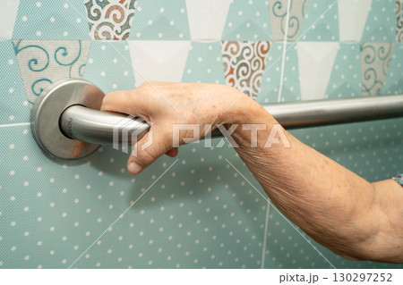 Asian elderly woman patient use toilet bathroom handle security in nursing hospital, healthy strong medical. 130297252