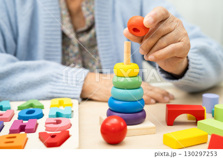 Alzheimer disease AD, Asian elderly woman patient suffering from dementia learn practical motor skills rehabilitation. Alzheimer disease AD, Asian elderly woman patient suffering from dementia learn practical motor skills rehabilitation. 130297253