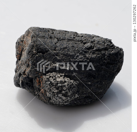 Raw Black Tourmaline Crystal Chunk with Granular Inclusions, Dark Tone, Mineral Specimen, Gemstone, Geology, Rough Stone Texture, Shadow Effects Raw Black Tourmaline Crystal Chunk with Granular Inclusions, Dark Tone, Mineral Specimen, Gemstone, Geology, Rough Stone Texture, Shadow Effects 130297262