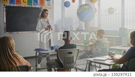 Female Doctor Giving Lecture to Curious Primary School Students About Health and Hygiene 130297411