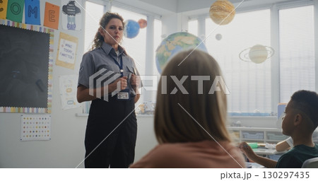 Female Police Officer Visiting Classroom, Giving Lecture to Curious Primary School Students Female Police Officer Visiting Classroom, Giving Lecture to Curious Primary School Students 130297435