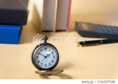 vintage pocket watch on student table. 130297586