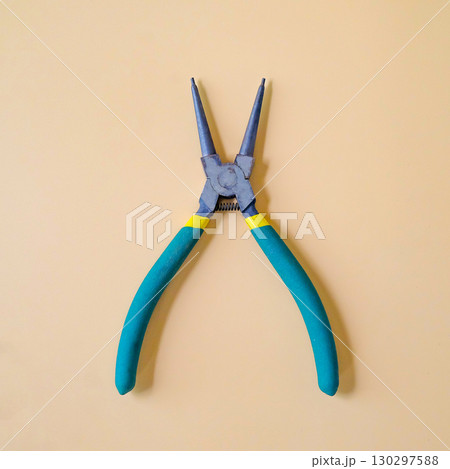 Round nose pliers or rosary pliers on color background. 130297588