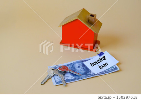 Housing loan text write on paper note and over on dollars,Finance and business concept. Housing loan text write on paper note and over on dollars,Finance and business concept. 130297618