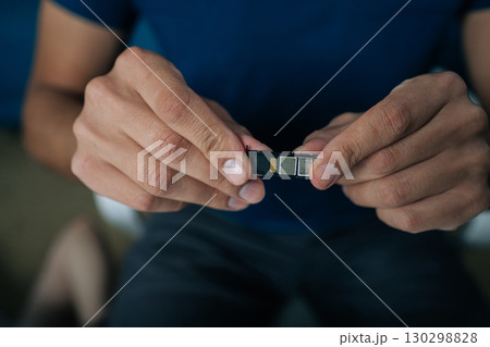 Cropped shot of skilled technician replacing smartphone sim card, demonstrating precise mobile repair technique with professional troubleshooting expertise. Concept of modern communication Cropped shot of skilled technician replacing smartphone sim card, demonstrating precise mobile repair technique with professional troubleshooting expertise. Concept of modern communication 130298828