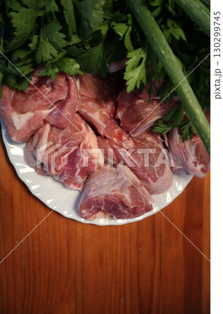 Fresh Lamb Meat with Parsley on Plate. Meat Prepared for Cooking. 130299745