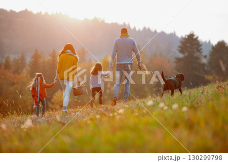 A portrait of young family with two small children in autumn nature at sunset. 130299798