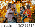 A portrait of young family with two small children in autumn nature at sunset. 130299812