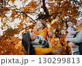 A portrait of young family with two small children in autumn nature at sunset. 130299813