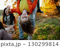 Father and young girl on walk in autumn nature, spending sunday outdoors. 130299814