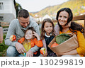 Sisters and parents in park during warm autumn day. 130299819