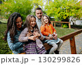 Family enjoing beautiful view during walk, warm autumn day. 130299826