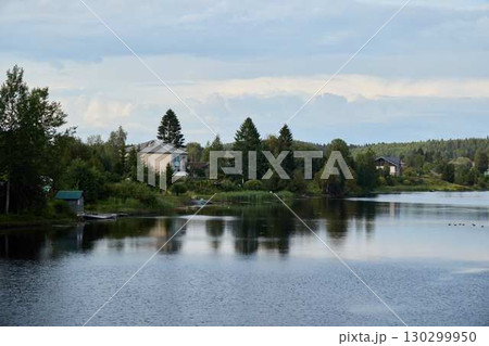 A Serene and Picturesque Lakeside Scene Featuring Lush Greenery and Beautiful Reflections A Serene and Picturesque Lakeside Scene Featuring Lush Greenery and Beautiful Reflections 130299950