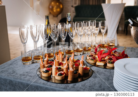 Elegant gourmet appetizers and champagne glasses set for a festive celebration 130300113