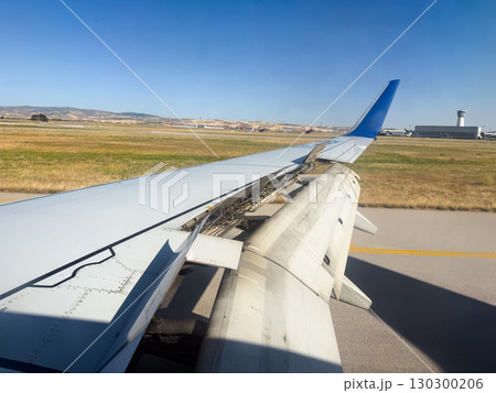 Airplane wing with extended spoilers during landing. Aviation technology, flight control, and aerodynamics in transport. 130300206