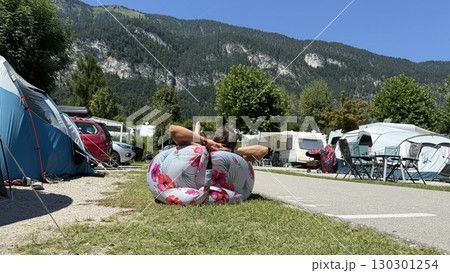 Relaxing at a Campsite with Inflatable Chair Relaxing at a Campsite with Inflatable Chair 130301254