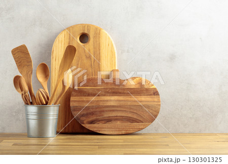 Wooden kitchen utensils on a wooden table. Wooden kitchen utensils on a wooden table. 130301325